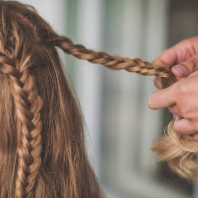 Person braiding hair of woman, Abbotsford, British Columbia, Canada